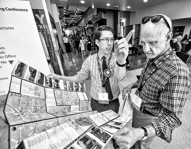 An association member gets directions from a student volunteer at a conference in Phoenix.