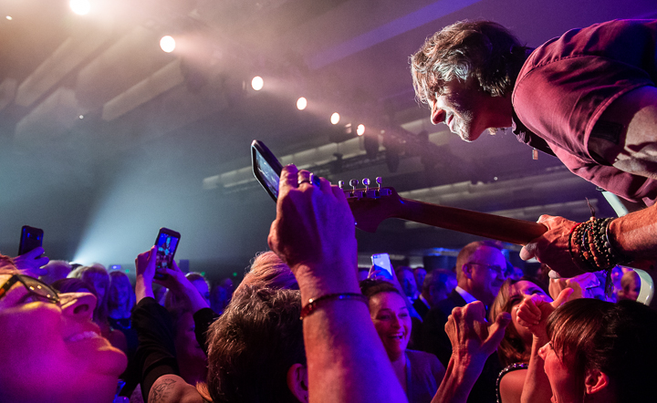 Rick Springfield simultaneously performs and poses for selfies during a corporate show in San Francisco.