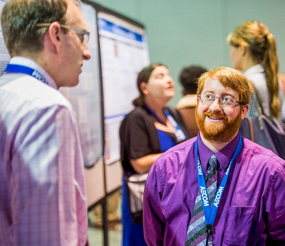 A planning student discusses his poster during the National Planning Conference in Atlanta.