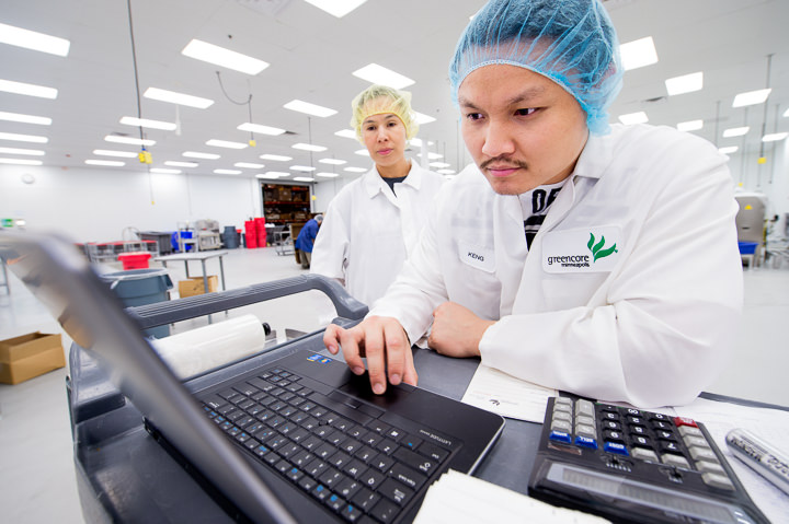 Technicians at the Greencore snack food plant south of Minneapolis review production data.