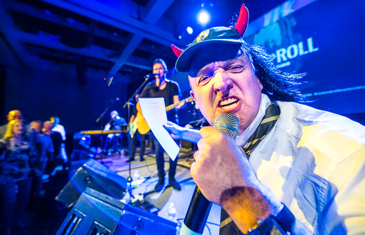 Dressed as Angus Young of AC/DC, an ILEA Live attendee in Calgary performs as part of a Rock & Roll team-building exercise.