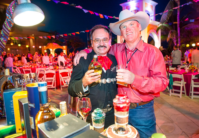 A tequila master poses with a leadership summit attendee in Cancun, Mexico.