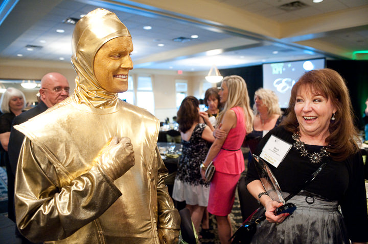 A 'living statue' breaks character, to the surprise of a Meeting Planners International member attending an MPI monthly meeting in Minnesota.
