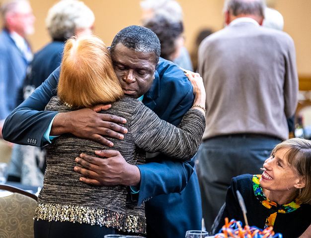 Reg Chapman, reporter for WCCO-TV in Minneapolis, hugs a long-time counselor at the Walkin Counseling Center during the center's 50th Anniversary Gala.
