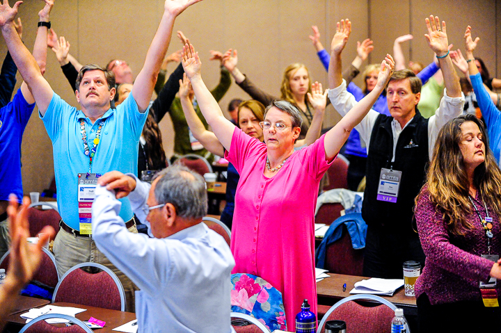 Massage therapists take a stretch break during a session at an AMTA conference in Minneapolis.