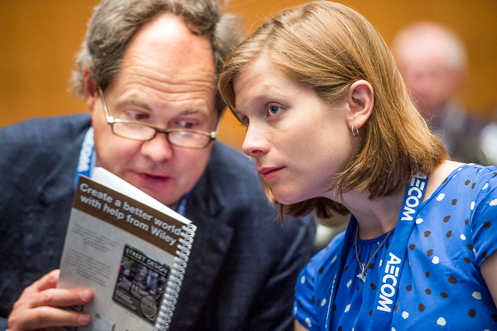 A breakout session attendee whispers a comment during an association conference in Atlanta.