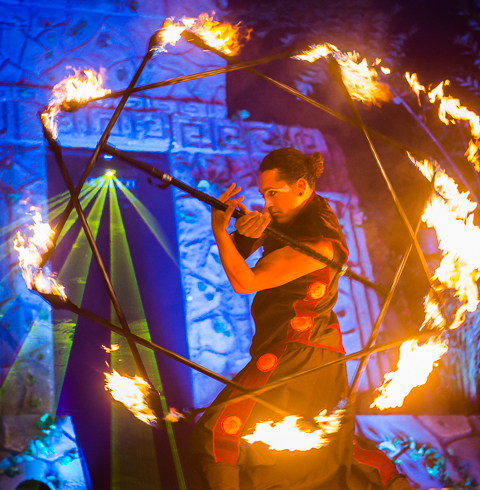 A juggler spins a flaming prop while performing during a corporate event in Cancun, Mexico.