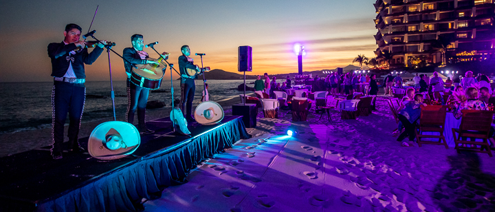 Traditional Mexican music accompanies dinner on the beach at a Los Cabos resort as part of an incentive event for top-performing financial representatives.