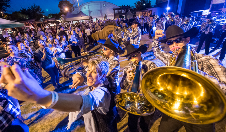 The house band at the Calgary Stampede help out a selfie-taker who was attending ILEA LIve.