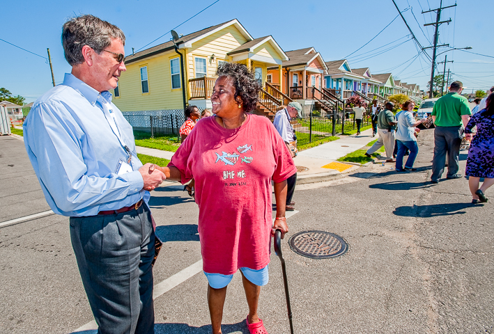 An urban planner in town for a planning conference chats with a resident of New Orleans' Lower Ninth ward about the slow recovery from Hurricane Katrina.