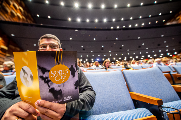 An attendee to United Way's CLIC in Toronto reads the program for the Songs of the City concert that traditionally kicks off the conference.