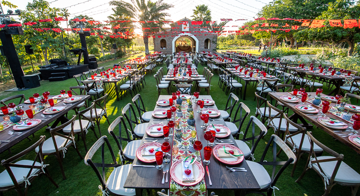 Tables are set and arranged for an outdoor corporate event at Flora Farms near San Jose del Cabo, Mexico.