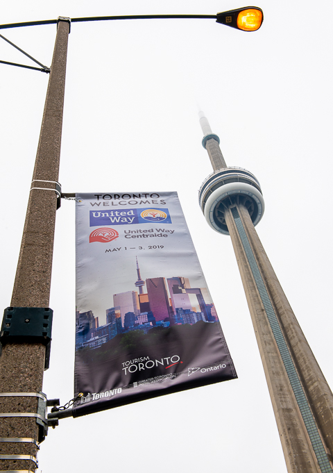 A street sign for United Way's CLIC conference near Toronto's CN Tower.