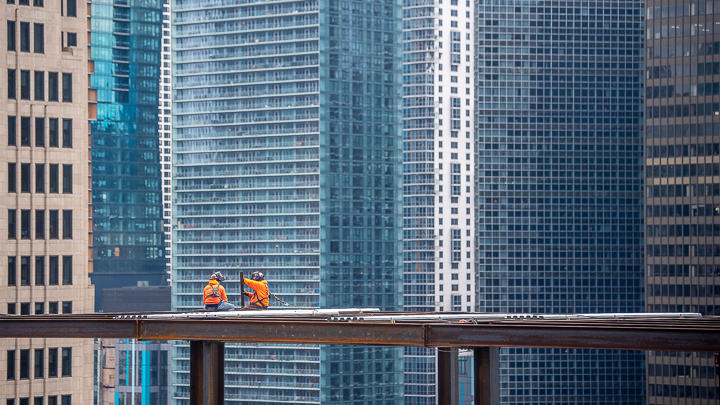 Two ironworkers work on an addition to the Tribune Tower in downtown Chicago.