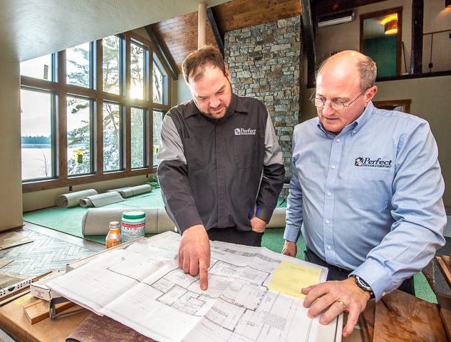 HVAC contractors look over plans for heating and cooling a new residential proprety in northern Wisconsin.