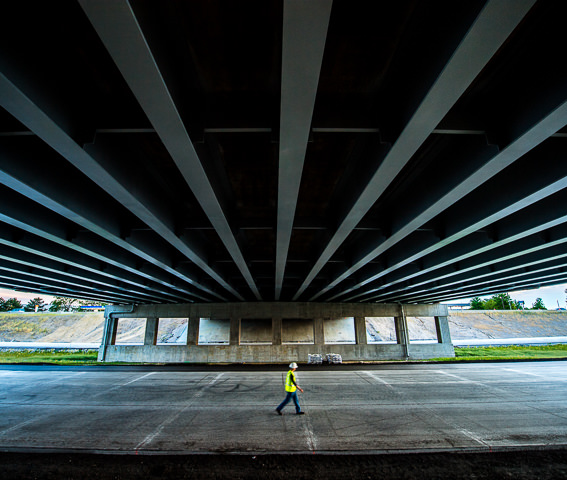 An engineer inspects the underside of a new highway bridge on the Illinois Tollway system.