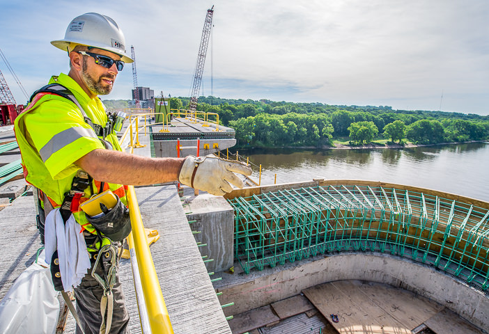 An engineer points out progress on rebuilding the Franklin Avenue bridge over the Mississippi River in Minneapolis.