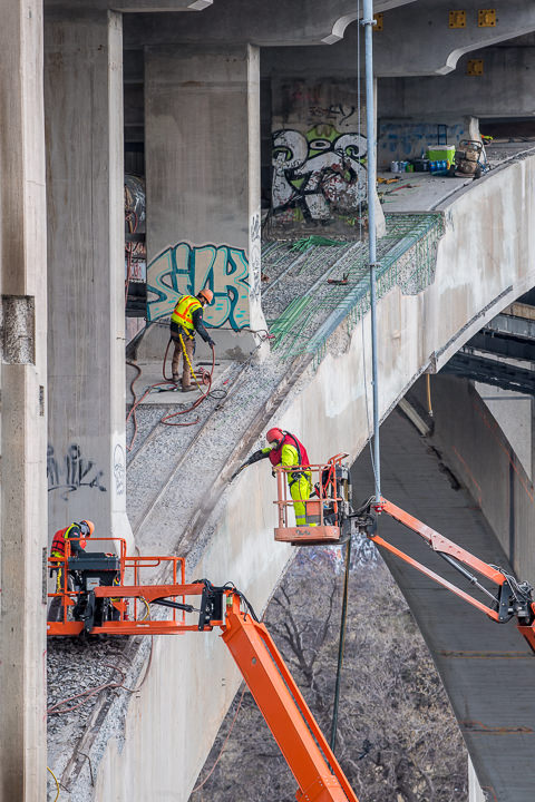 Crews apply shotcrete to exposed areas of the Franklin Avenue Bridge in Minneapolis.